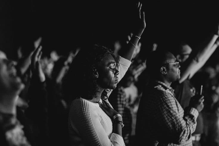 Hands raised in worship at a Christian gathering
